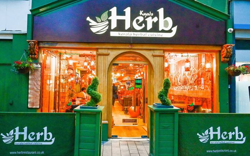 The entrance to Herb Restaurant in Leicester, lit up in the evening